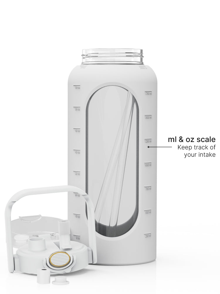 2-liter glass water bottle with grey protective sleeve, straw lid, carry handle, and ml and oz measurement scale.
