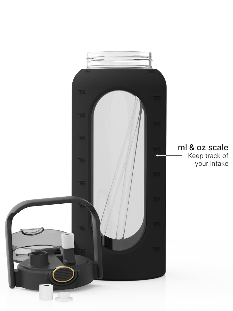 2-liter glass water bottle with black protective sleeve, straw lid, carry handle, and ml and oz measurement scale.