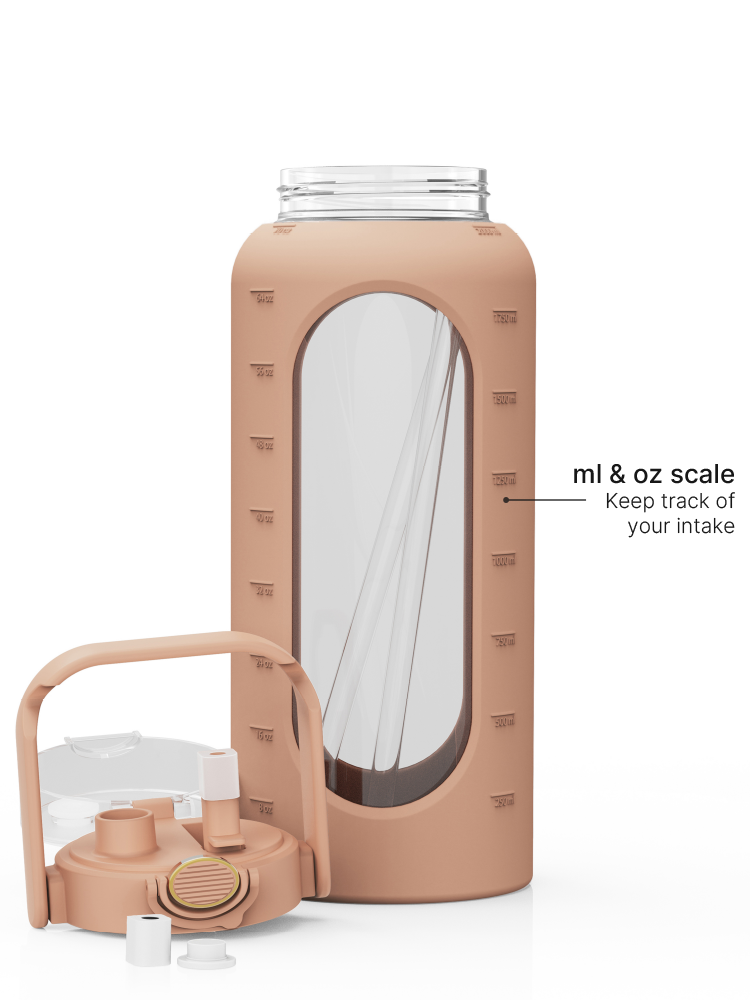 2-liter glass water bottle with brown protective sleeve, straw lid, carry handle, and ml and oz measurement scale.